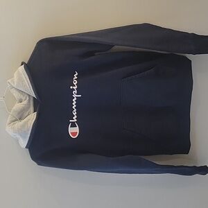 Champion youth XL sweatshirt hoodie dark blue with white letters.
